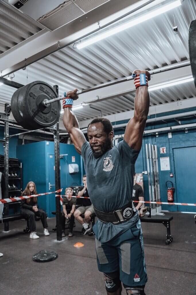 a man lifting a barbell in a gym