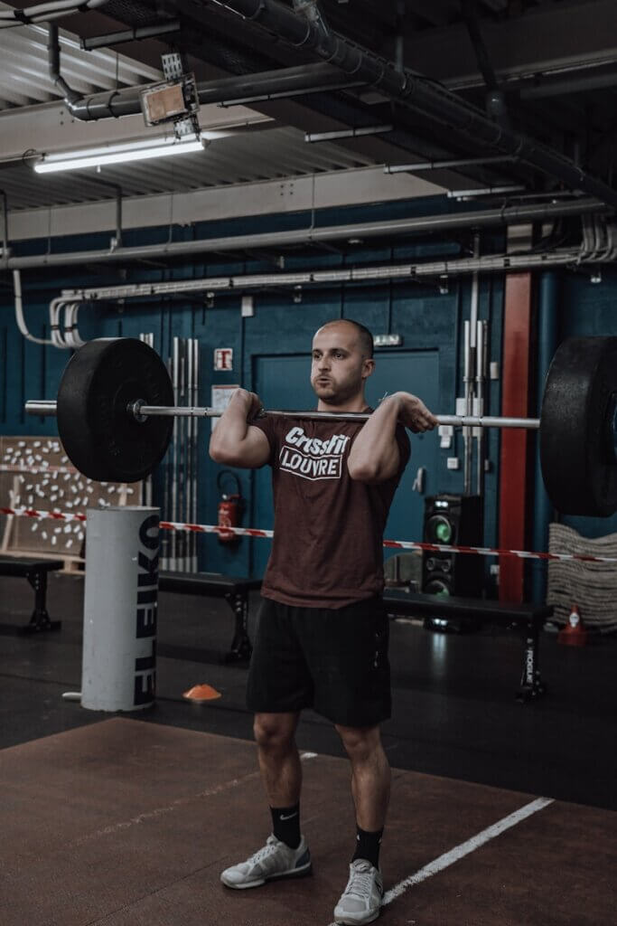 a man in a gym lifting a barbell