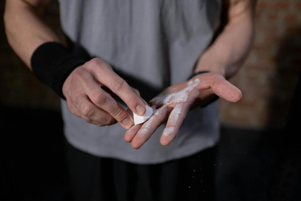 Close-Up View of a Person Putting Talc in His Hands