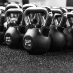 a row of kettles lined up in a gym